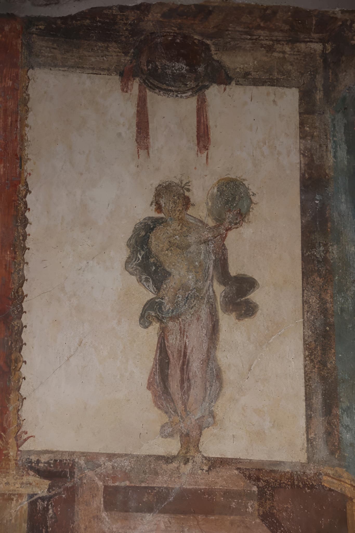 A painted figure of the Muse Urania from the south wall of a room in the House of the Vettii at Pompeii.